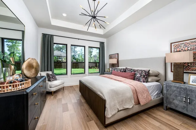a bedroom with a bed and glass windows