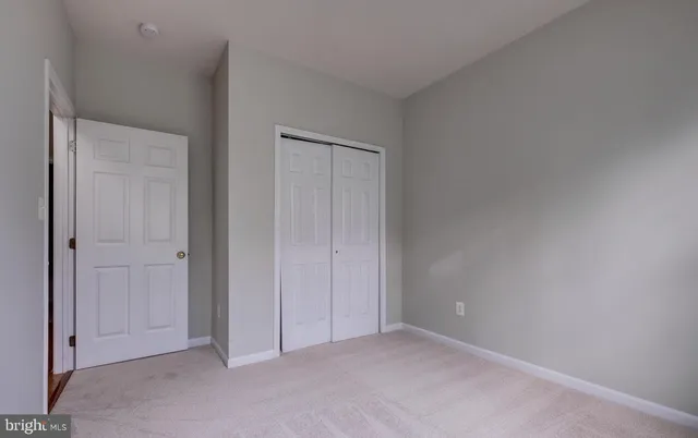 a view of an empty room and closet area