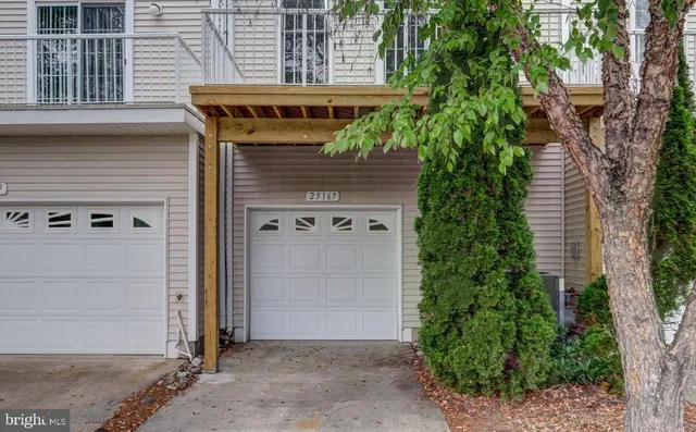 a front view of a house with trees