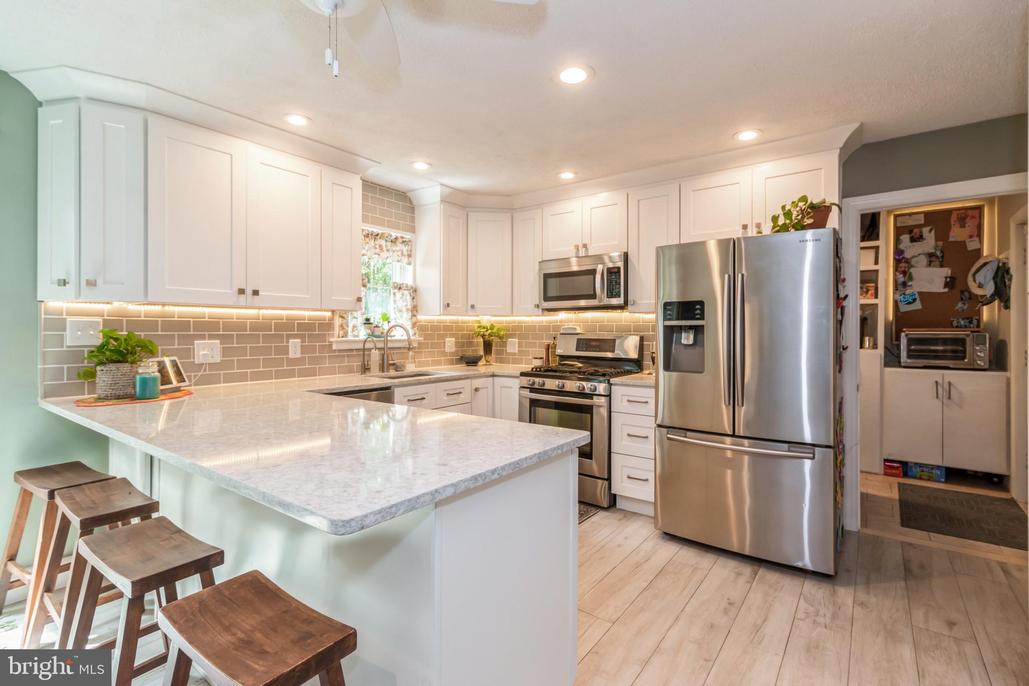 504 Tuckerton Road Medford, NJ 08055 - Photo 8 of 24 a kitchen with kitchen island a refrigerator stove and sink