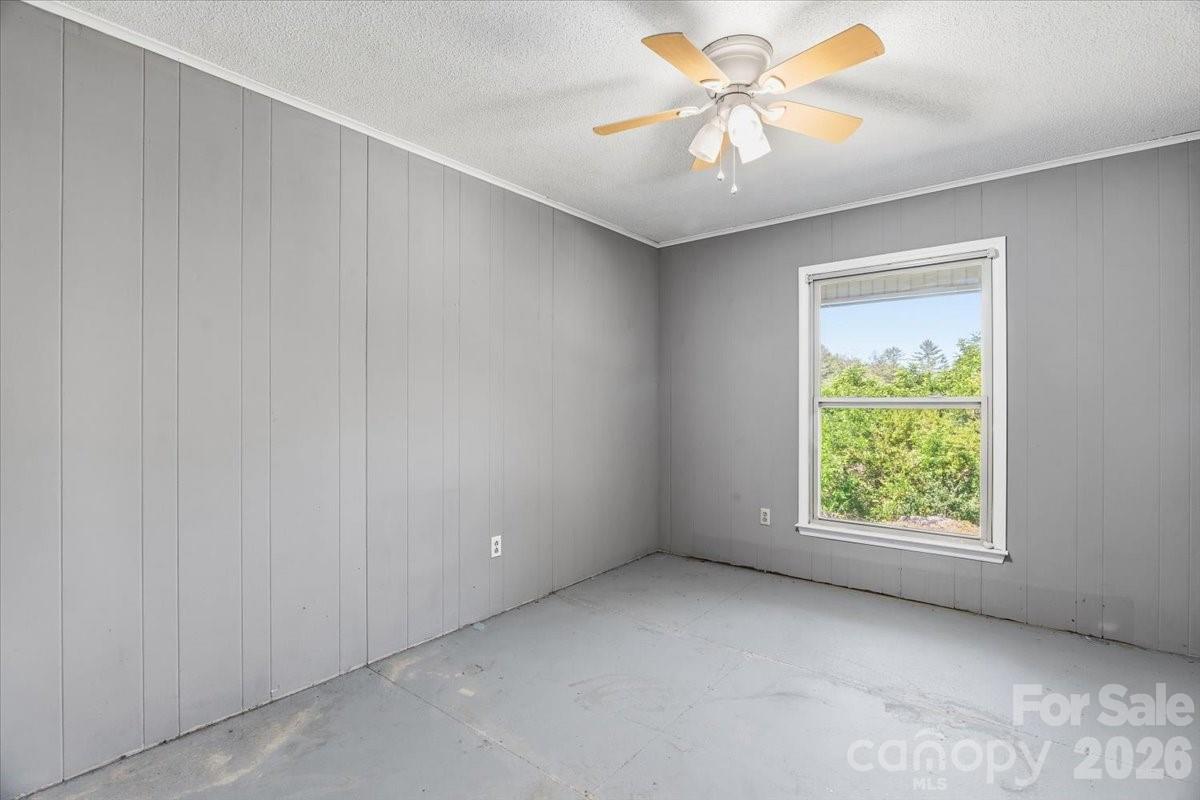 14 Jack Sullins Road Spruce Pine, NC 28777 - Photo 21 of 37 an empty room with windows and fan