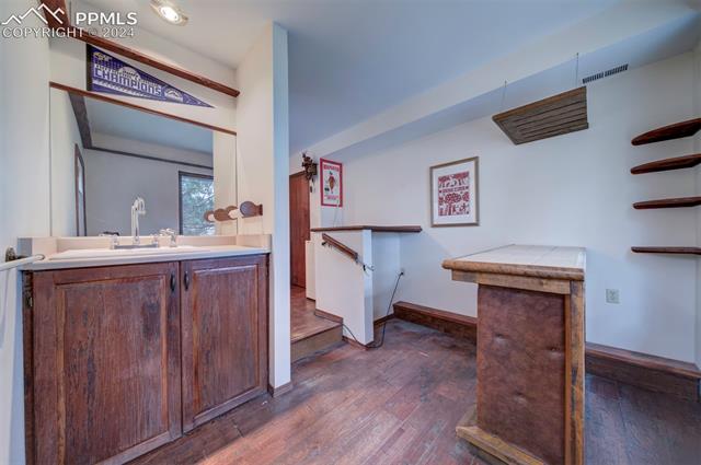 18255 Stoneview Road Monument, CO 80132 - Photo 39 of 42 Bathroom with hardwood / wood-style floors and vanity