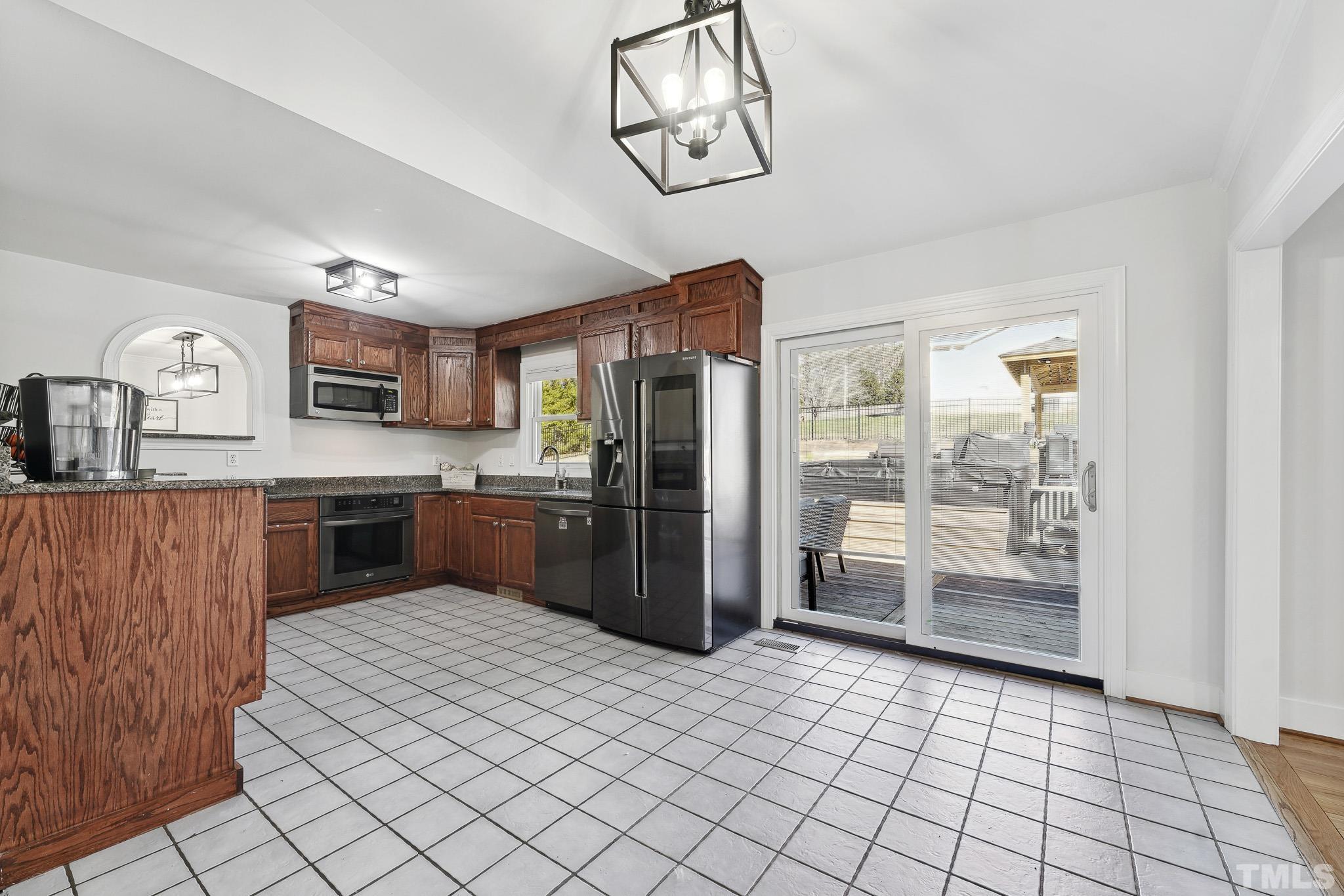 2632 Purnell Road Wake Forest, NC 27587 - Photo 11 of 60 a kitchen with stainless steel appliances granite countertop a refrigerator and a sink