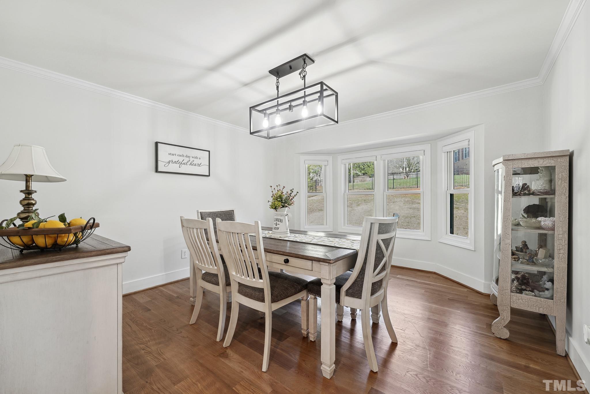 2632 Purnell Road Wake Forest, NC 27587 - Photo 16 of 60 a view of a dining room with furniture window and wooden floor