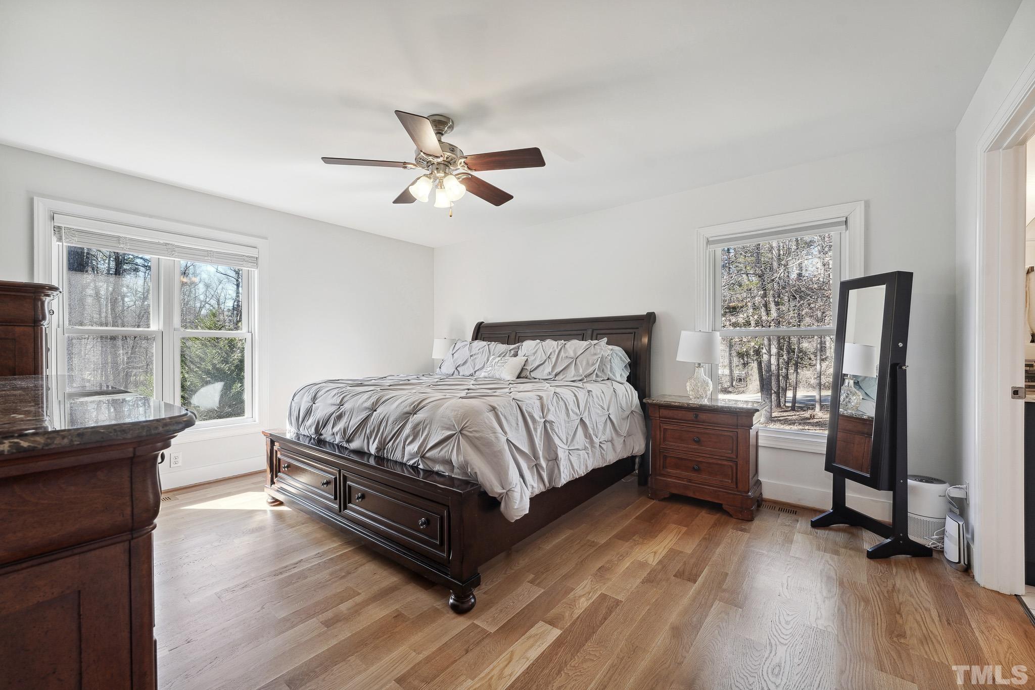 2632 Purnell Road Wake Forest, NC 27587 - Photo 17 of 60 a spacious bedroom with a bed and wooden floor