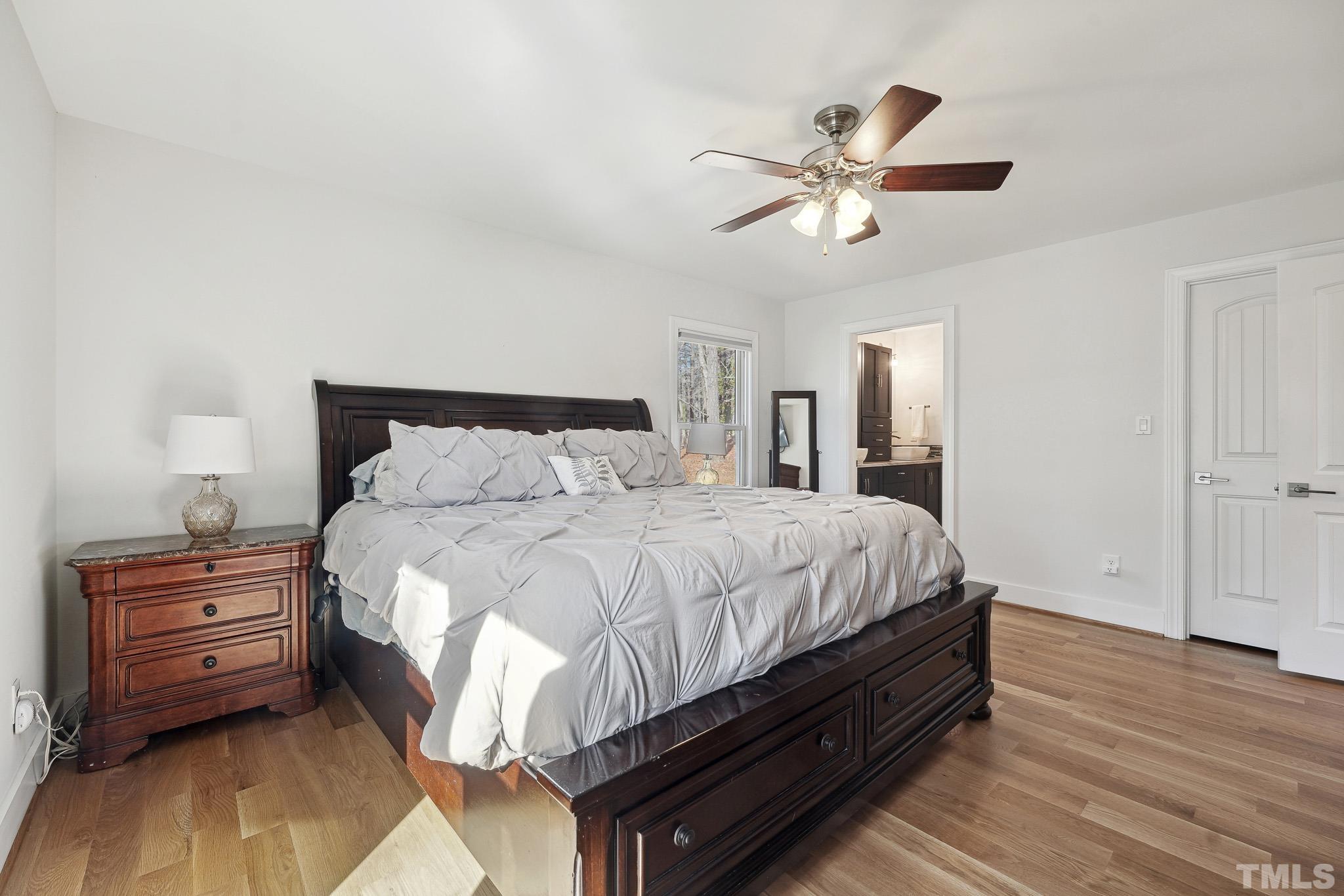 2632 Purnell Road Wake Forest, NC 27587 - Photo 18 of 60 a bedroom with a bed and a chandelier