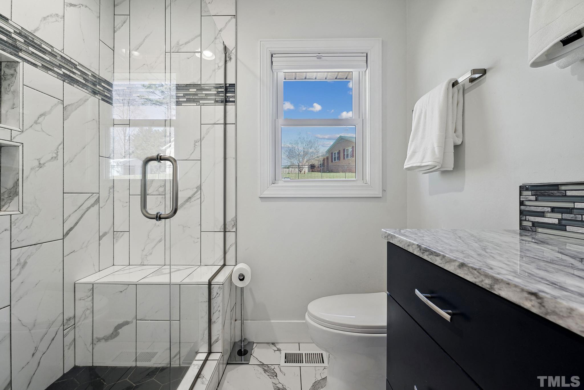 2632 Purnell Road Wake Forest, NC 27587 - Photo 20 of 60 a bathroom with a granite countertop sink a toilet and shower