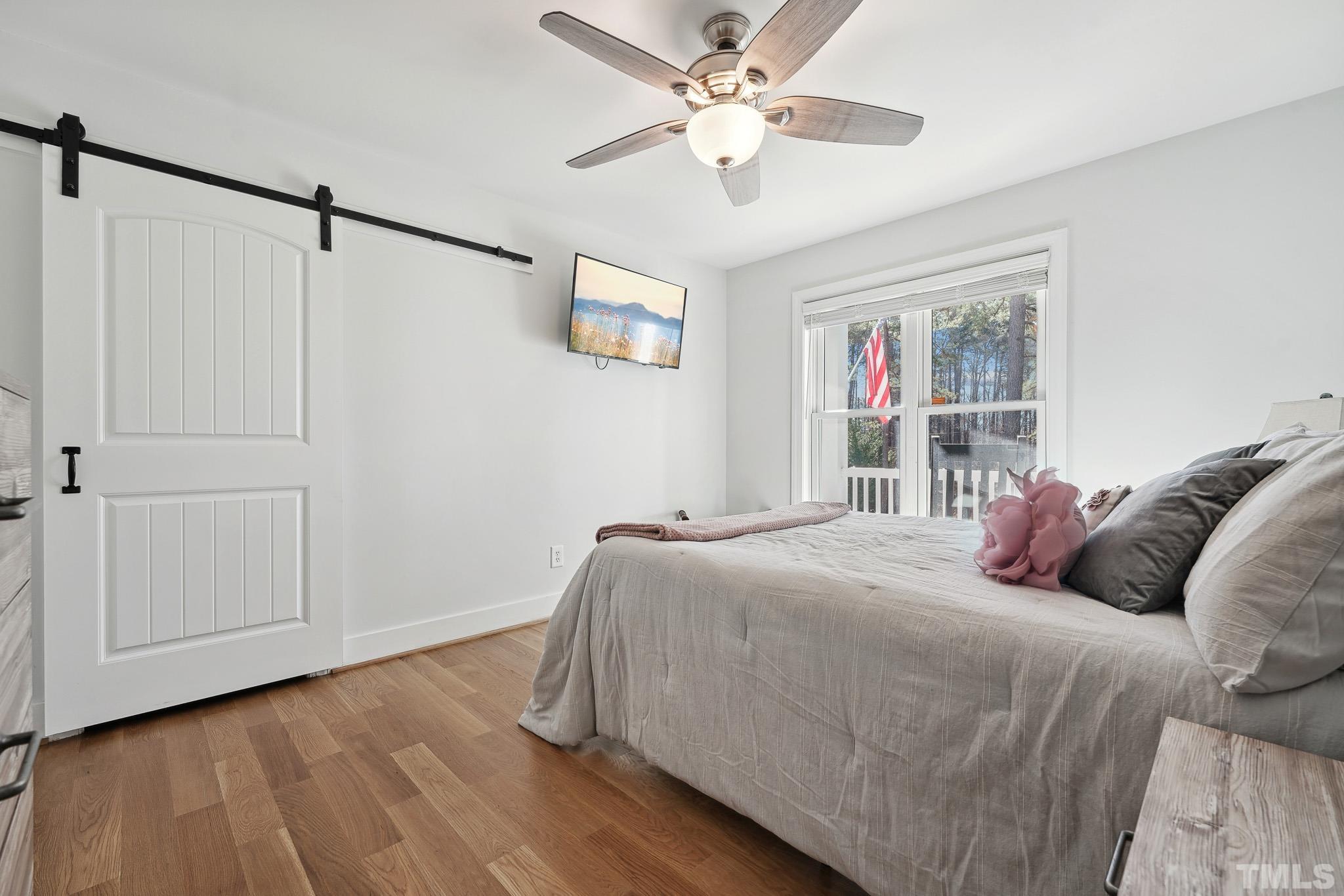 2632 Purnell Road Wake Forest, NC 27587 - Photo 22 of 60 a bed room with a bed and a ceiling fan
