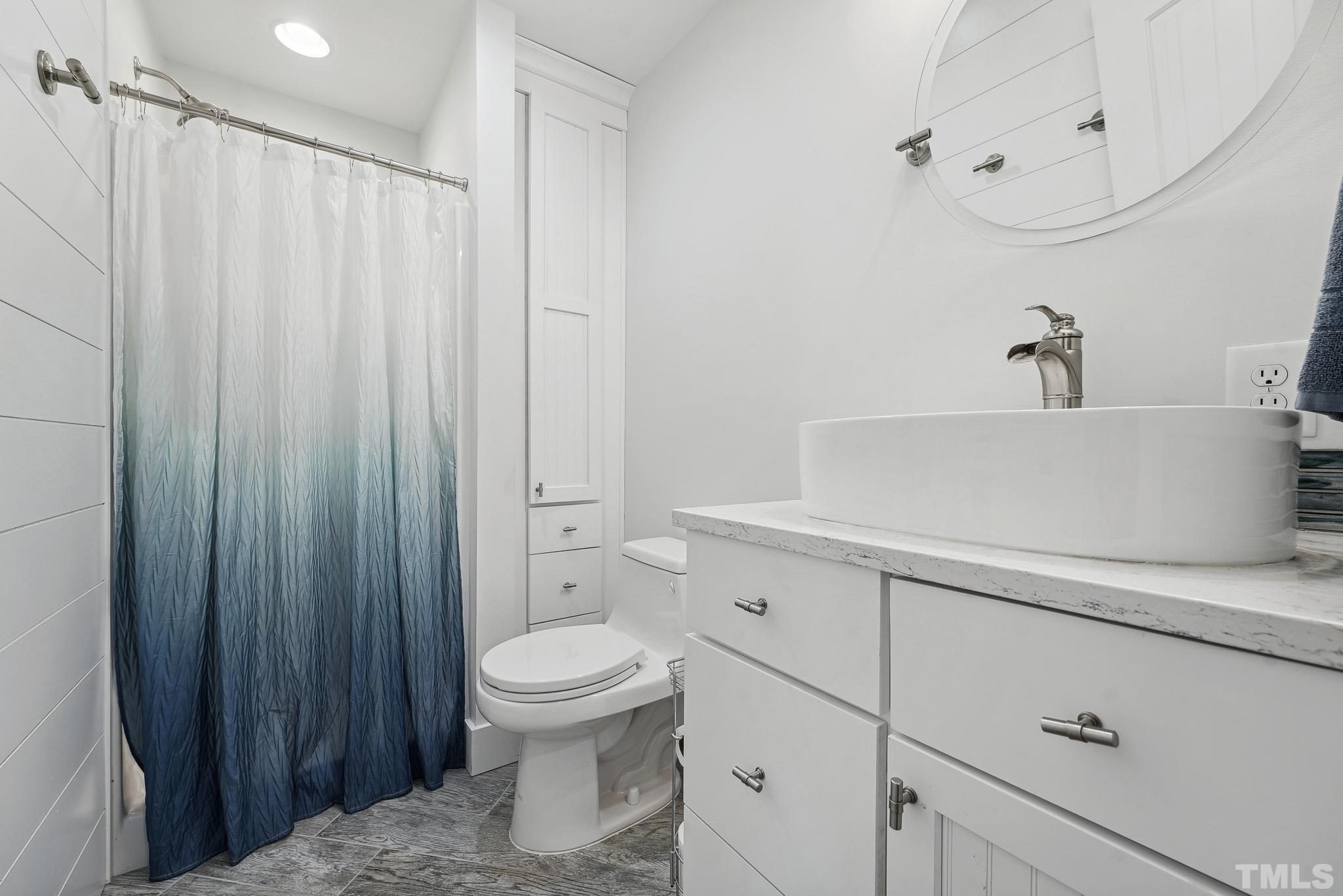 2632 Purnell Road Wake Forest, NC 27587 - Photo 23 of 60 a bathroom with a sink a toilet and shower