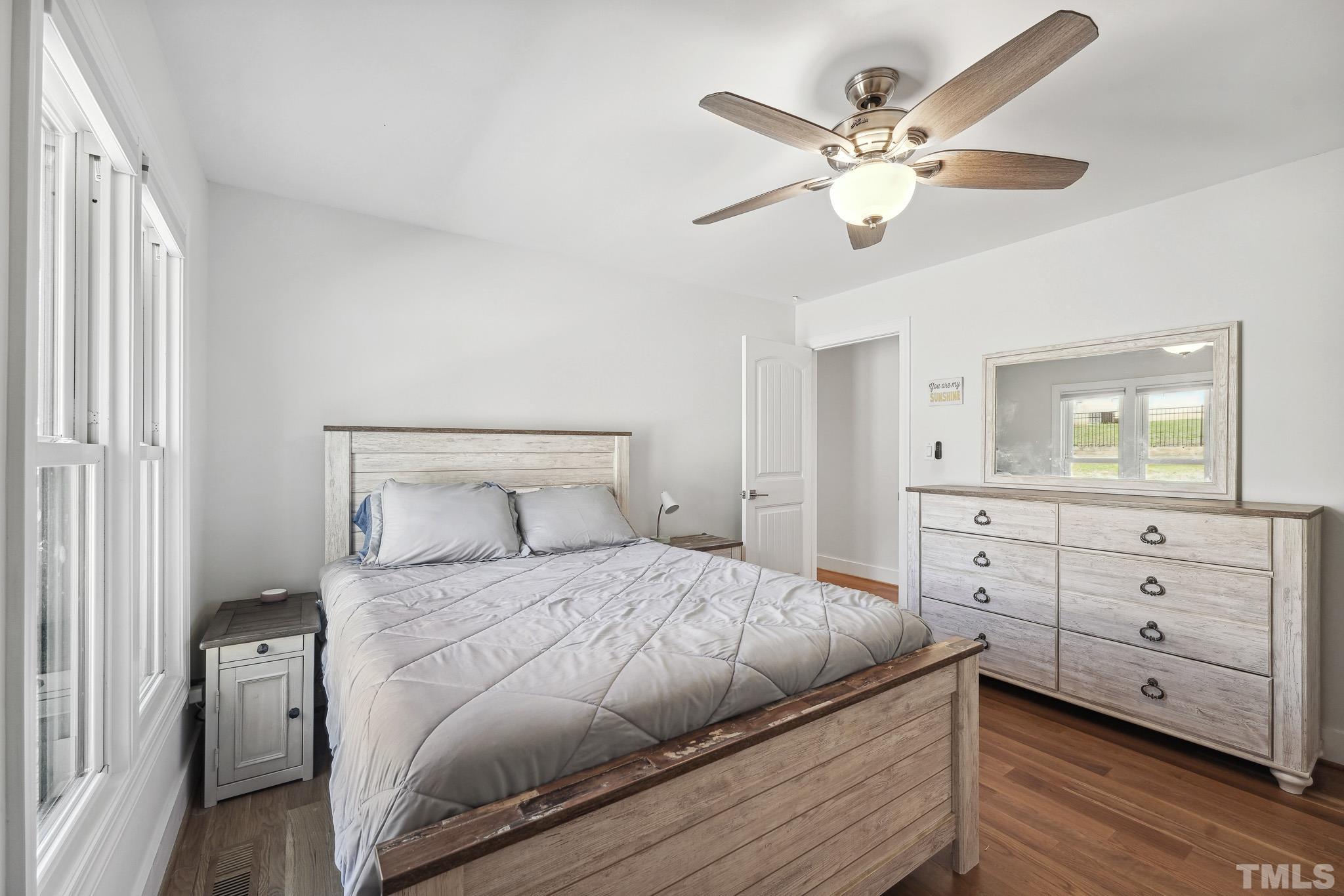 2632 Purnell Road Wake Forest, NC 27587 - Photo 24 of 60 a bedroom with a bed and a chandelier