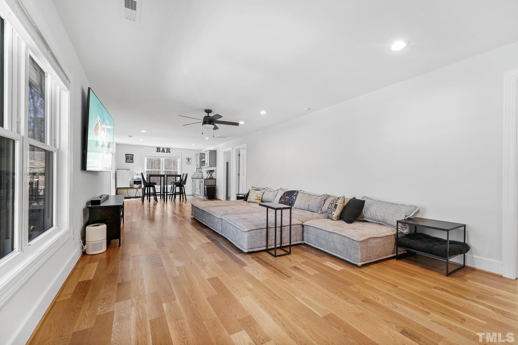 2632 Purnell Road Wake Forest, NC 27587 - Photo 29 of 60 a living room with couches and kitchen view with wooden floor