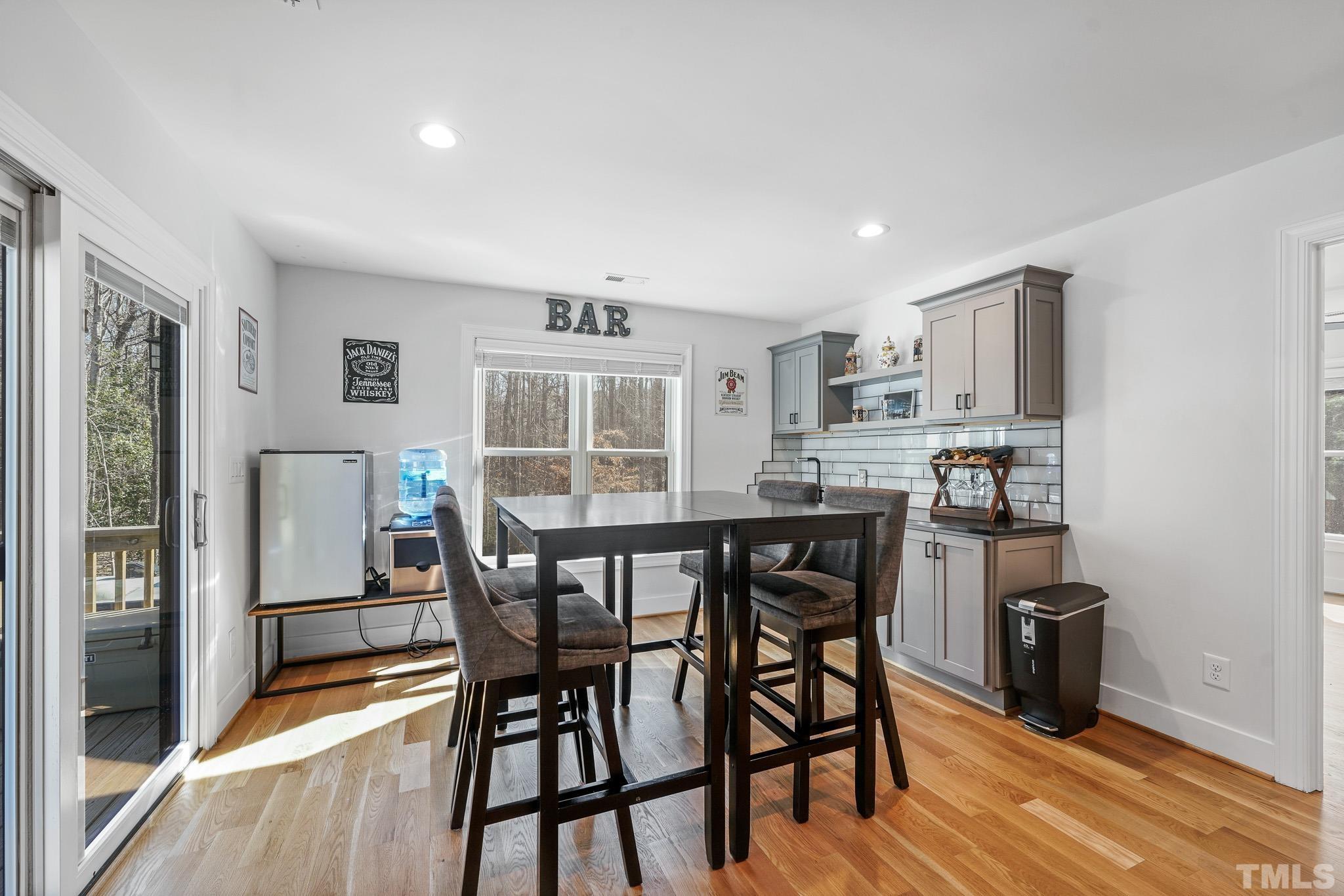 2632 Purnell Road Wake Forest, NC 27587 - Photo 32 of 60 a kitchen with stainless steel appliances granite countertop a dining table chairs refrigerator and sink
