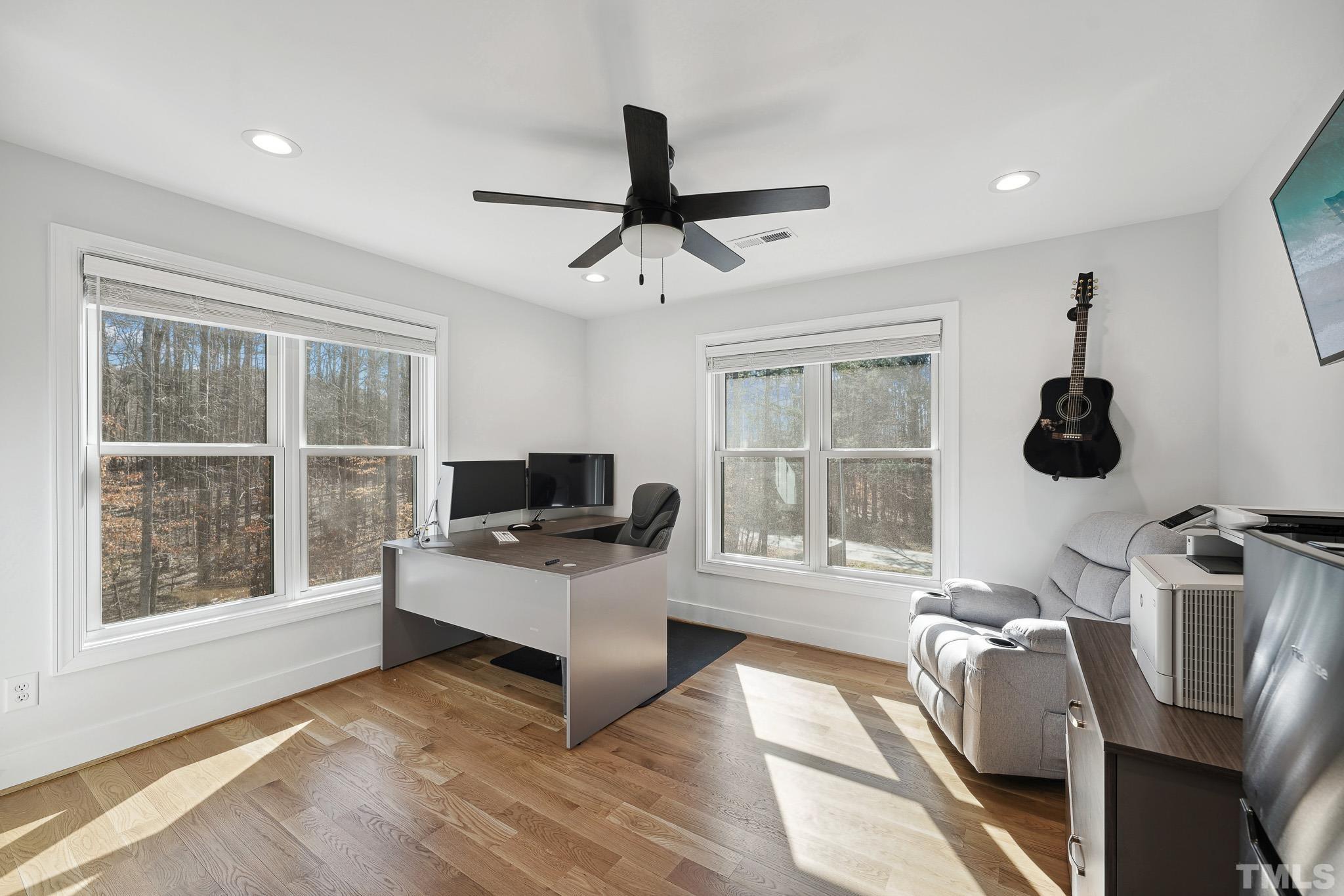 2632 Purnell Road Wake Forest, NC 27587 - Photo 33 of 60 a living room with furniture a flat screen tv and a large window