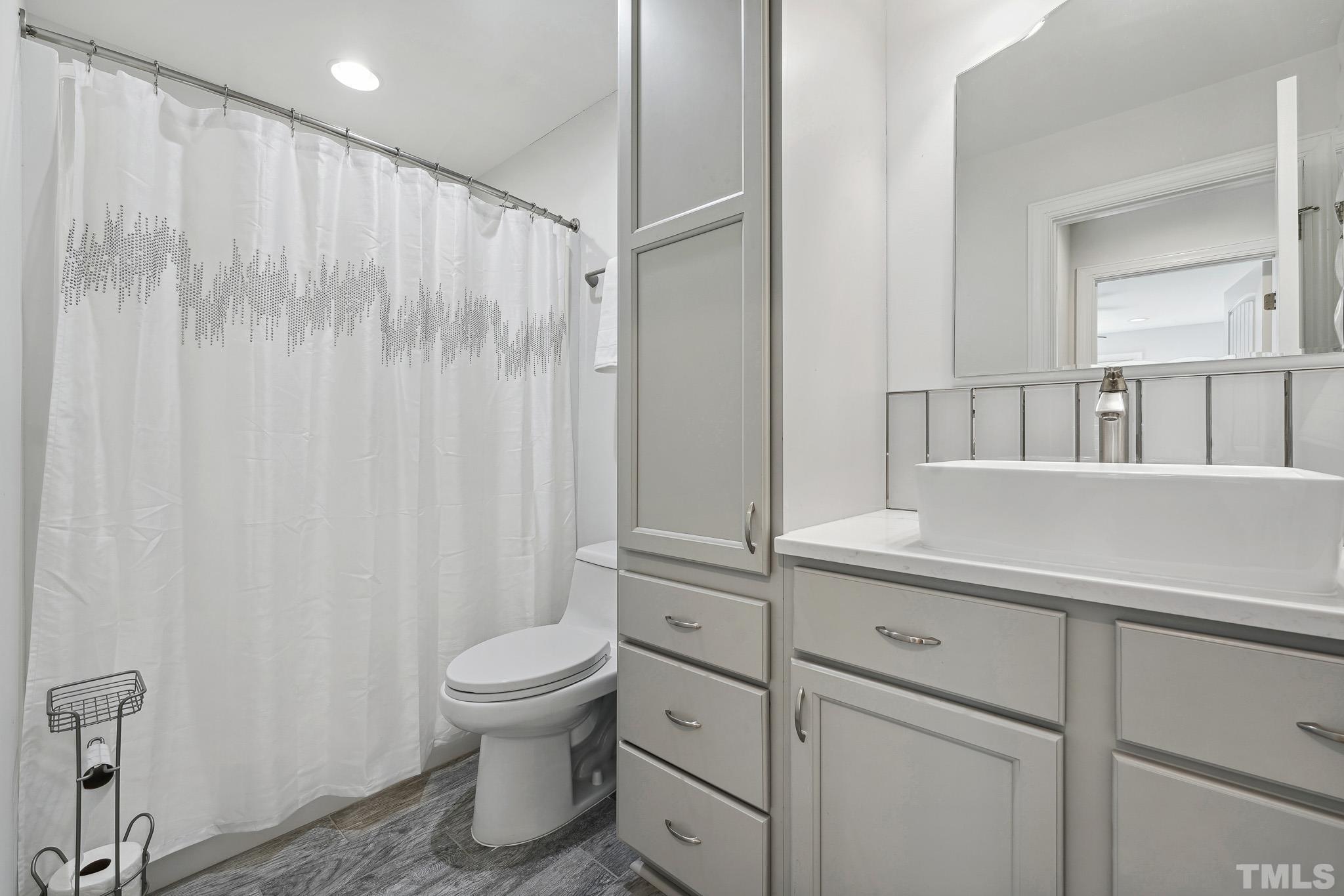 2632 Purnell Road Wake Forest, NC 27587 - Photo 40 of 60 a bathroom with a sink a toilet and shower