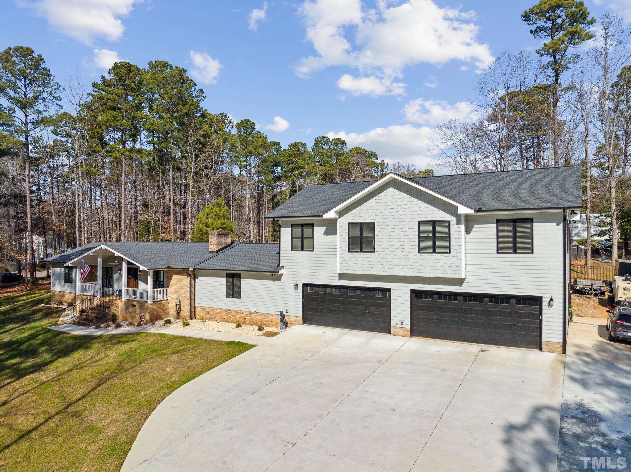 2632 Purnell Road Wake Forest, NC 27587 - Photo 4 of 60 a front view of a house with a yard outdoor seating and garage