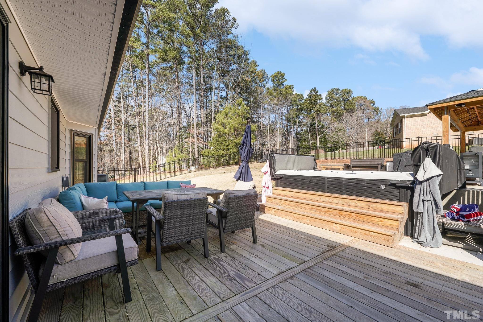 2632 Purnell Road Wake Forest, NC 27587 - Photo 44 of 60 a view of a patio with couches table and chairs with wooden floor and fence