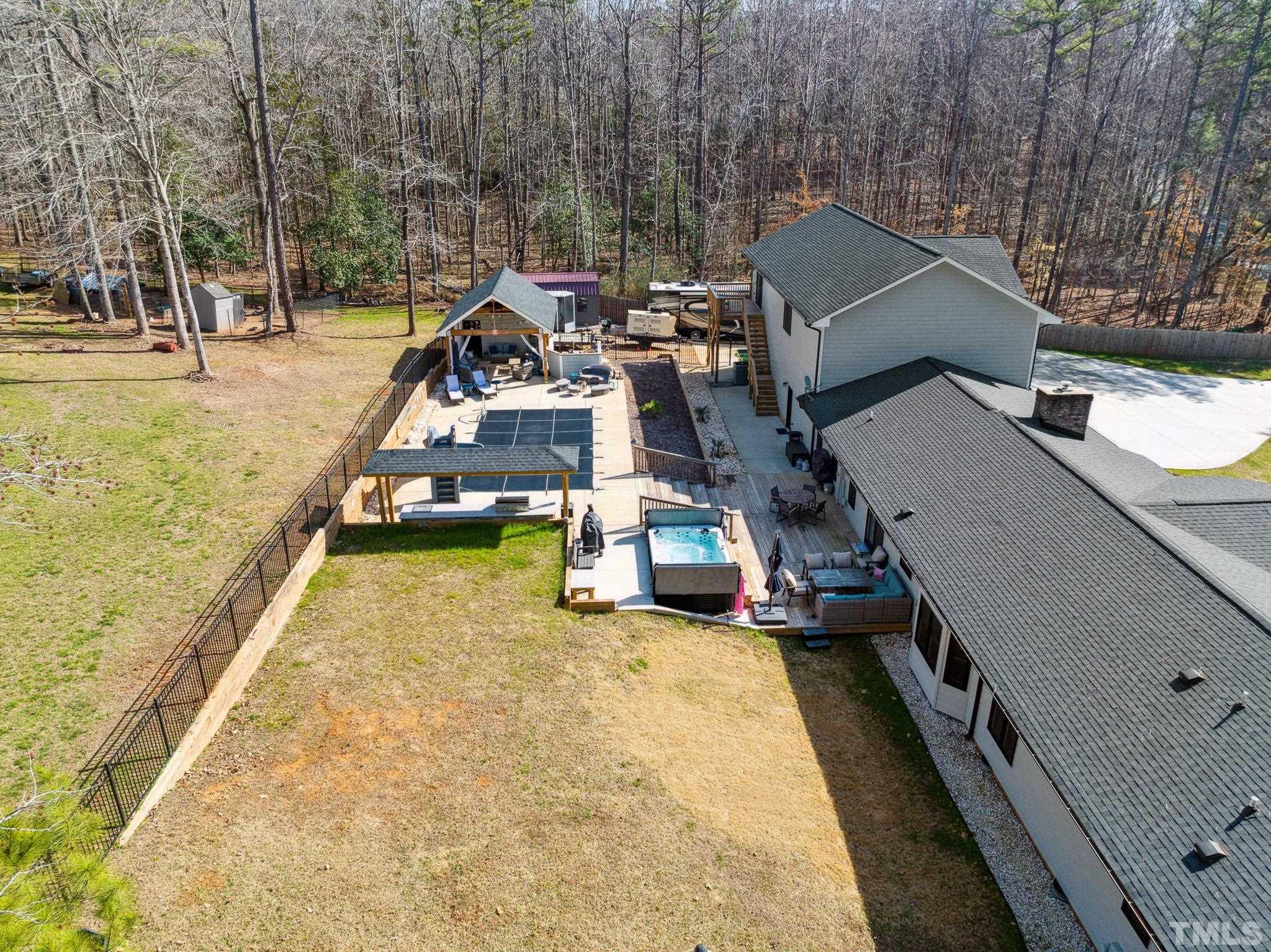 2632 Purnell Road Wake Forest, NC 27587 - Photo 56 of 60 an aerial view of a house with swimming pool and large trees