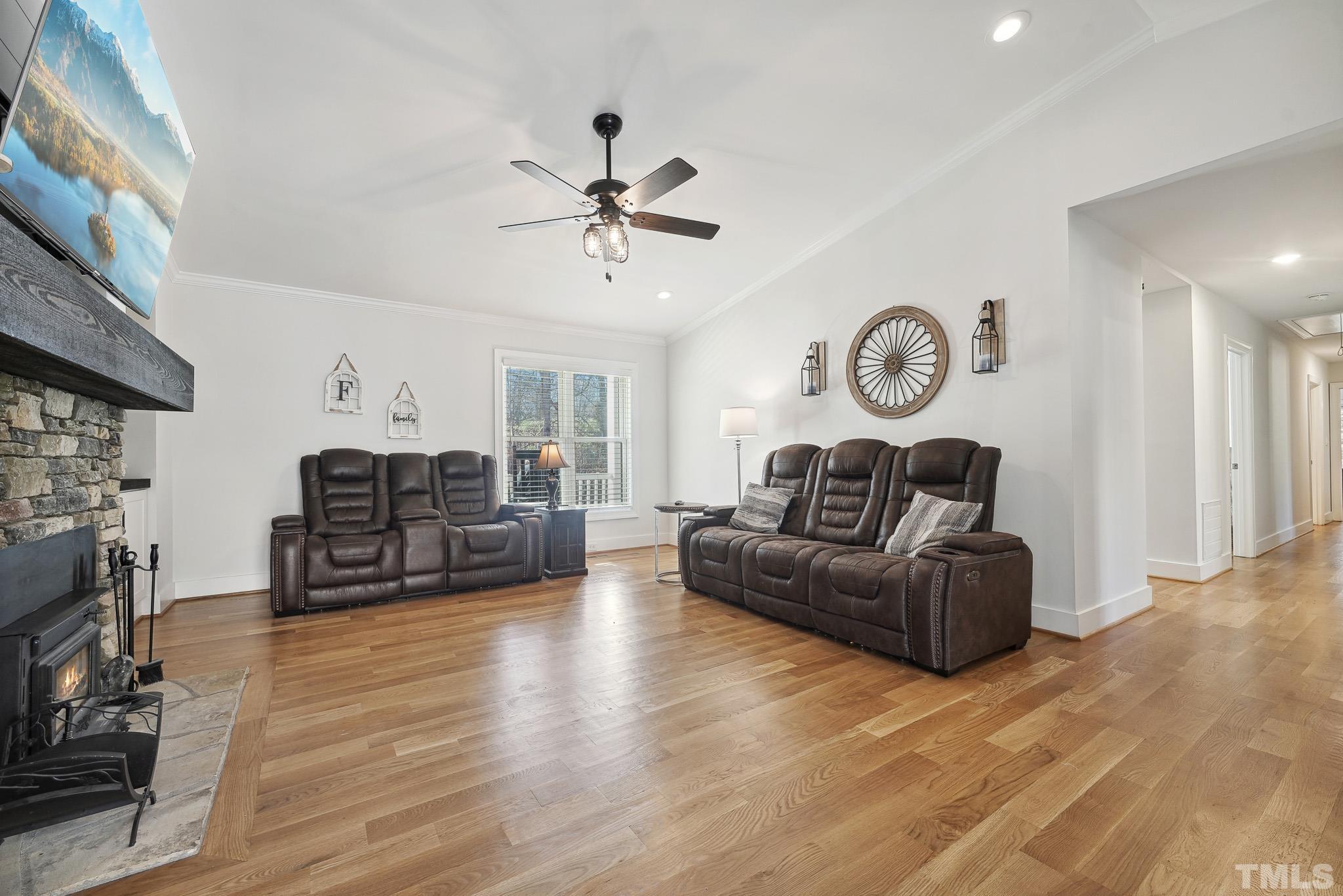 2632 Purnell Road Wake Forest, NC 27587 - Photo 7 of 60 a living room with furniture a clock and wooden floor