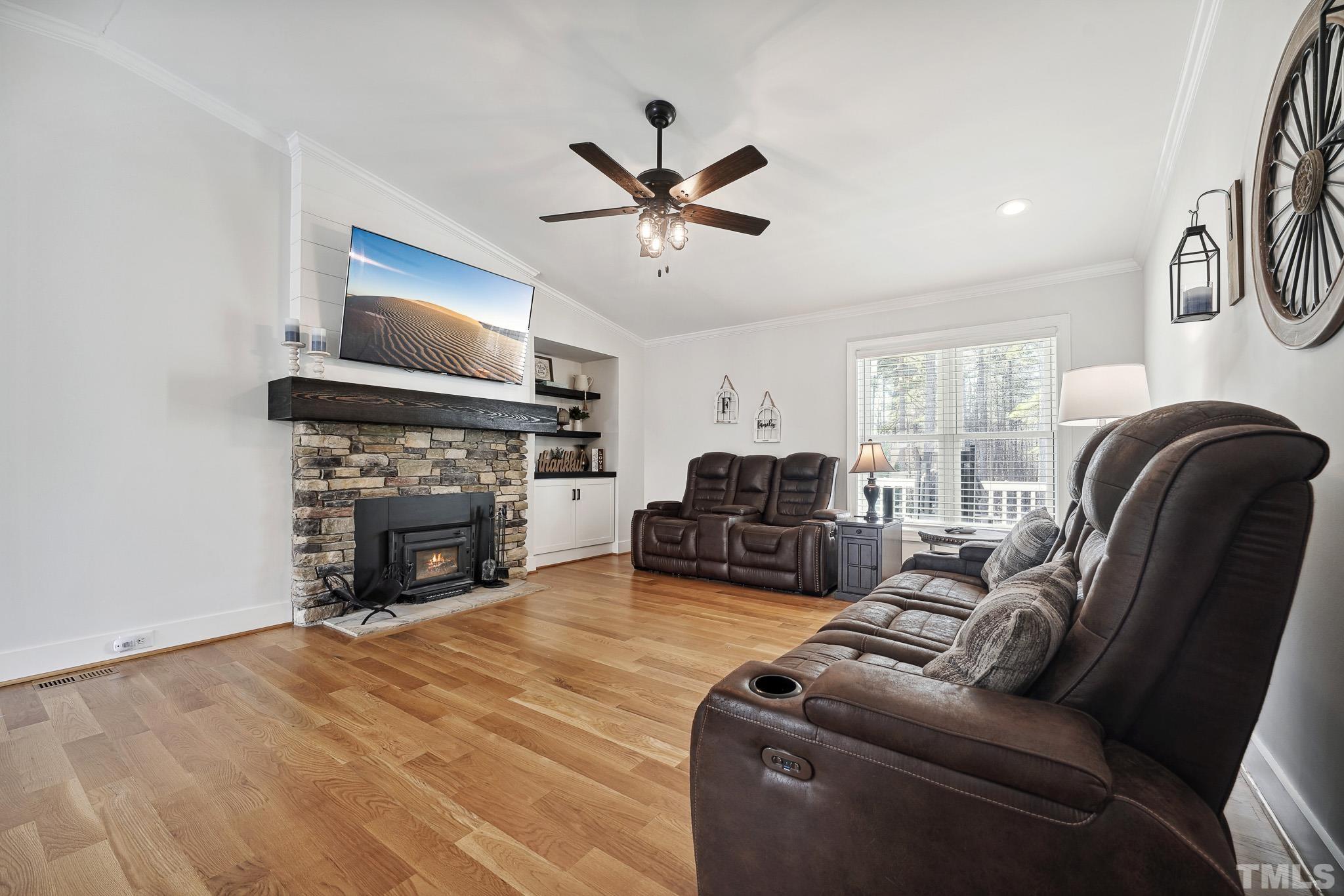 2632 Purnell Road Wake Forest, NC 27587 - Photo 8 of 60 a living room with furniture a fireplace and a flat screen tv