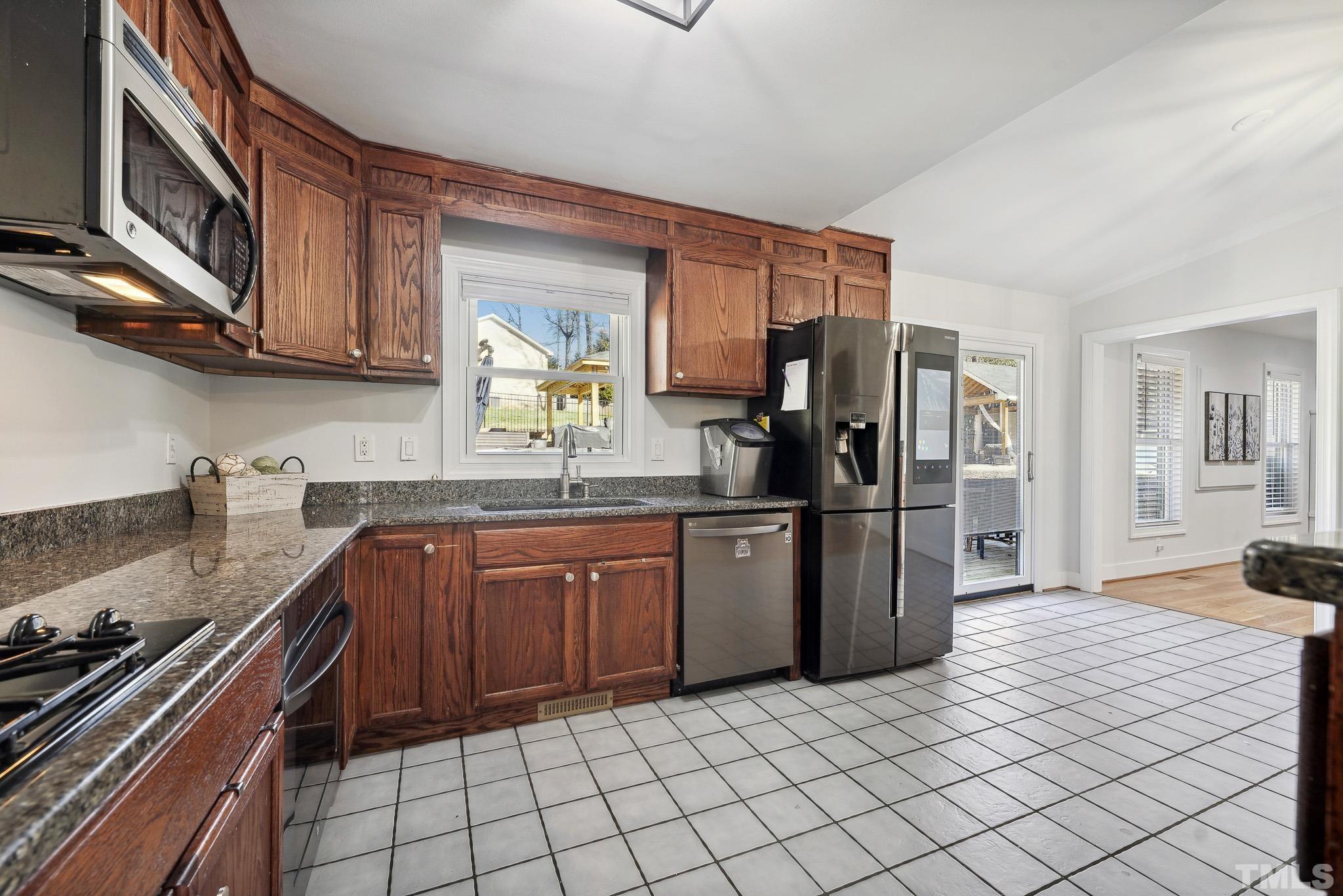2632 Purnell Road Wake Forest, NC 27587 - Photo 10 of 60 a kitchen with stainless steel appliances granite countertop a refrigerator and a stove top oven
