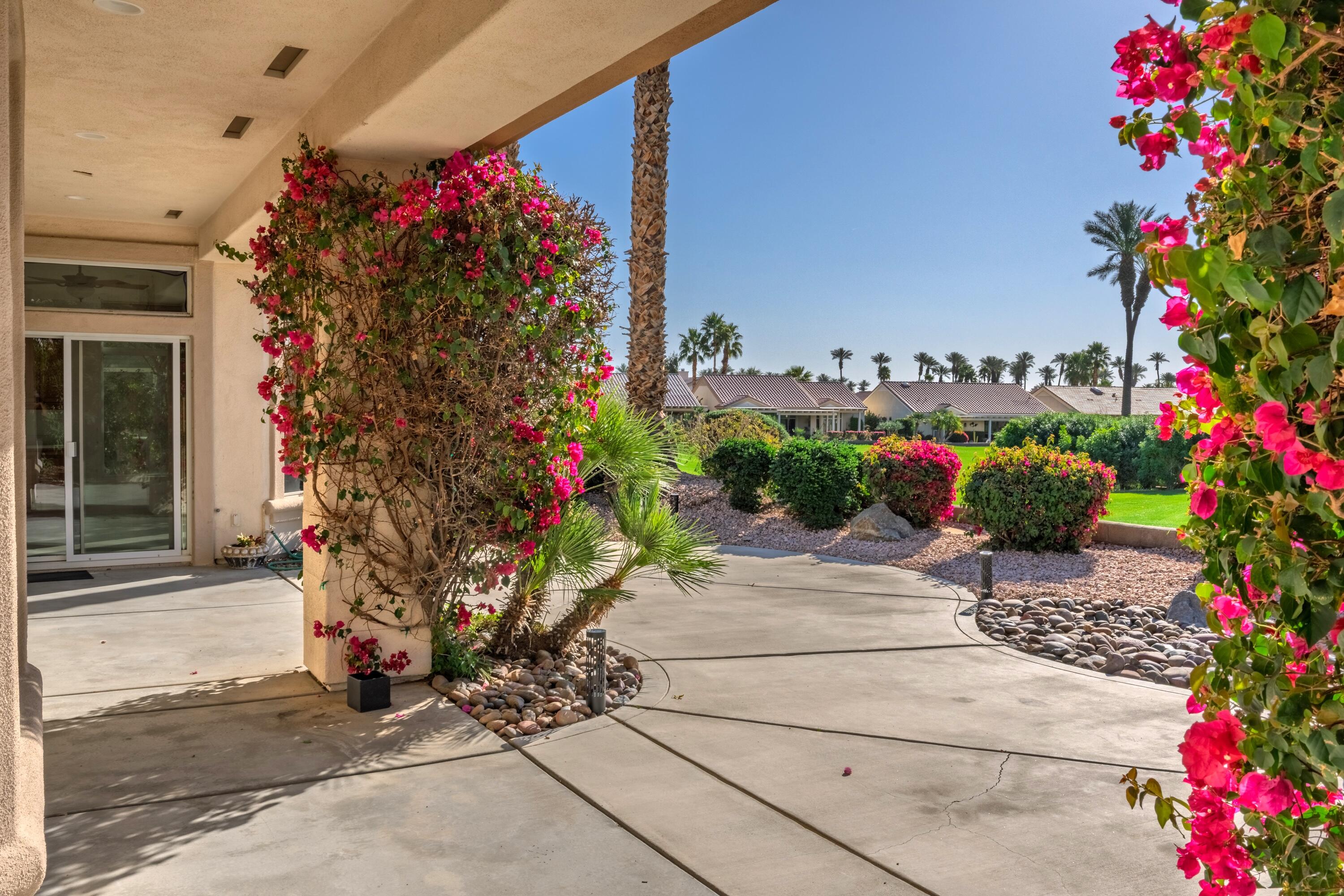 35440 Moorbrook Road Palm Desert, CA 92211 - Photo 30 of 32 a potted plant sitting in front of a house