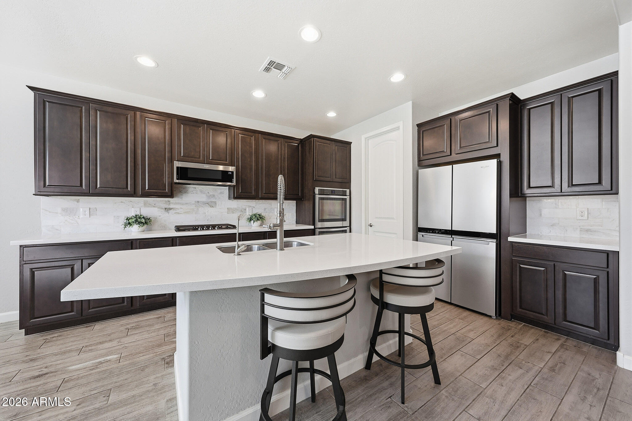 22133 East Russet Road Queen Creek, AZ 85142 - Photo 3 of 61 a kitchen with cabinets a sink and appliances