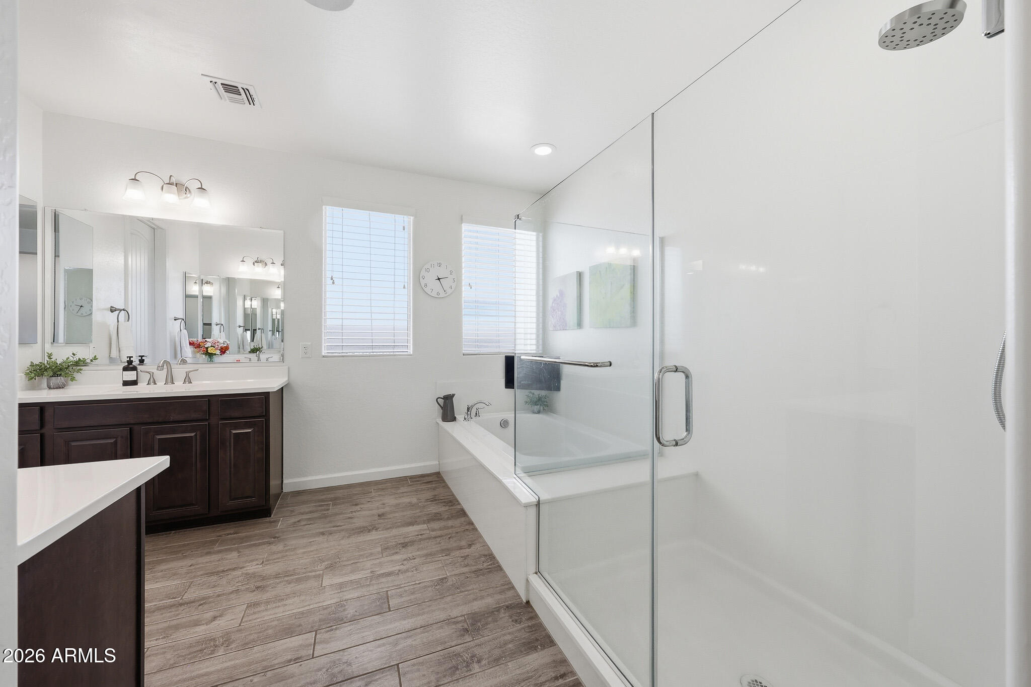 22133 East Russet Road Queen Creek, AZ 85142 - Photo 32 of 61 a spacious bathroom with a double vanity sink a mirror and a bathtub