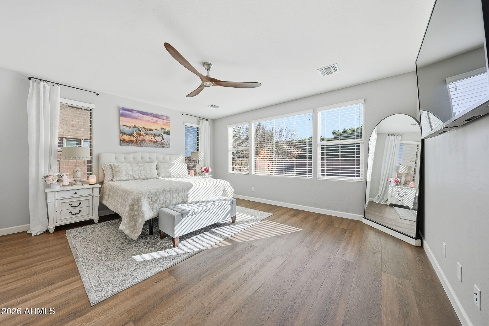 22133 East Russet Road Queen Creek, AZ 85142 - Photo 38 of 61 a spacious bedroom with a bed a dresser next to a window