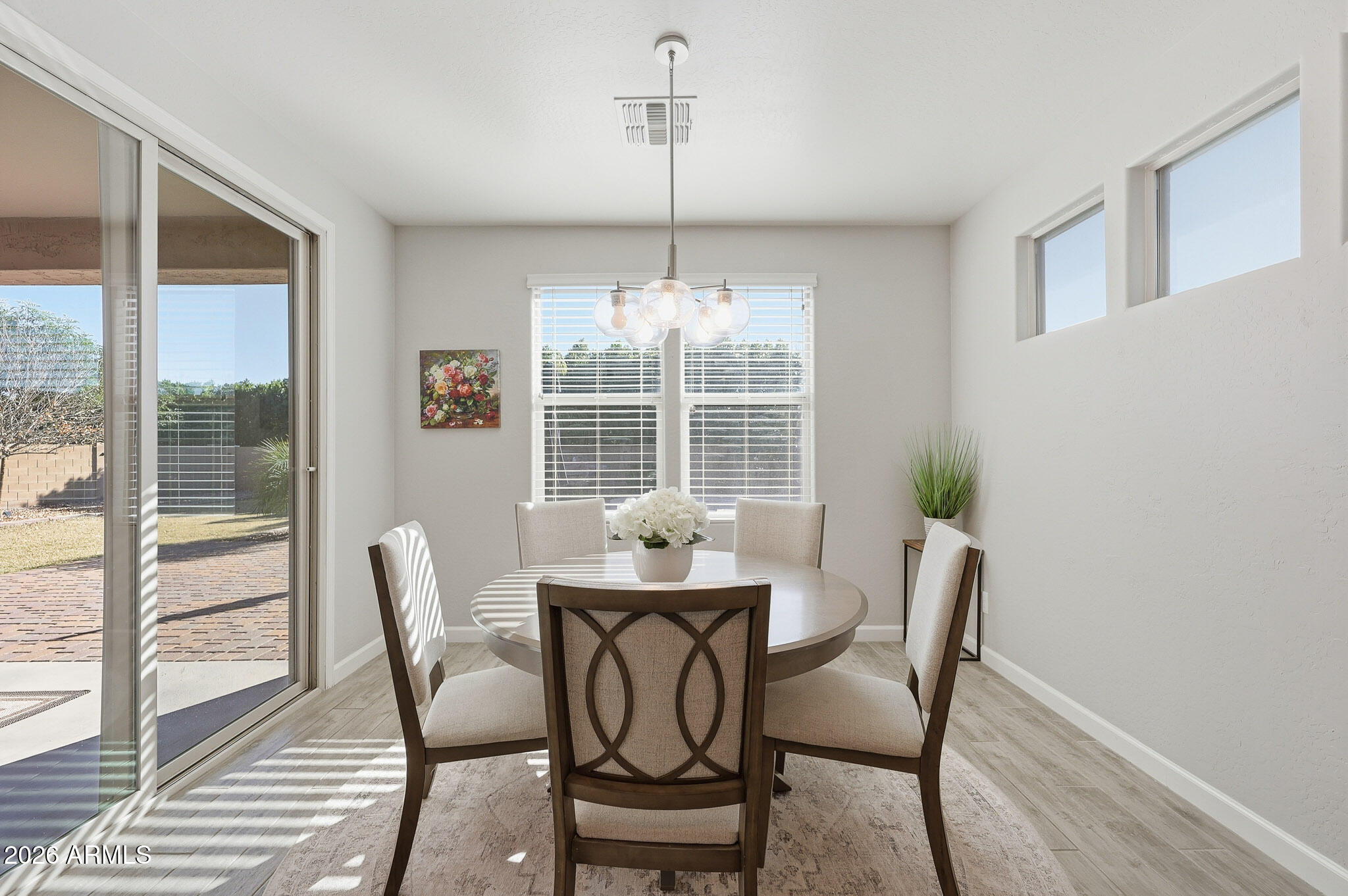 22133 East Russet Road Queen Creek, AZ 85142 - Photo 41 of 61 a dining room with furniture a chandelier and wooden floor