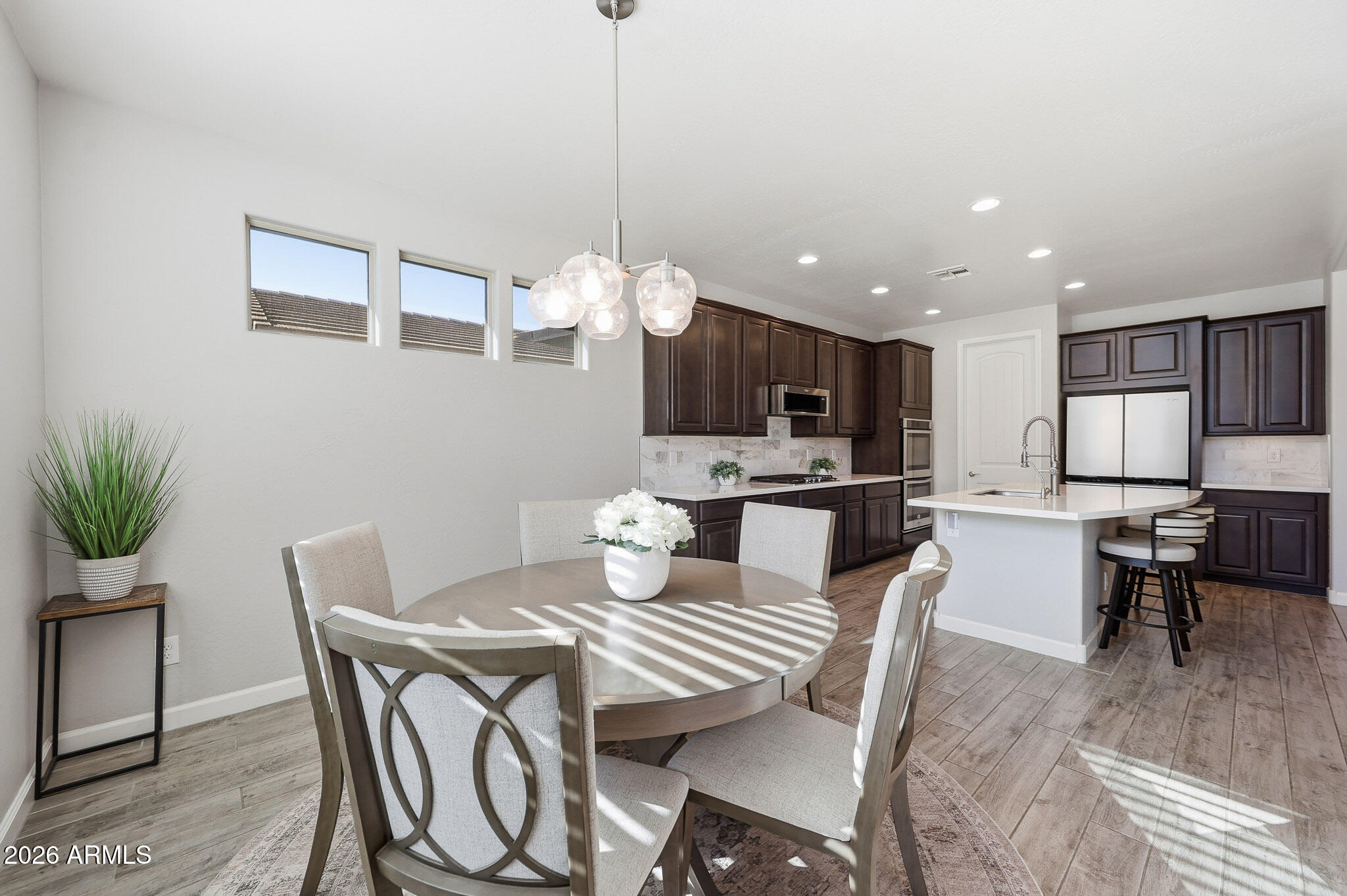 22133 East Russet Road Queen Creek, AZ 85142 - Photo 43 of 61 a view of a dining room and livingroom with furniture wooden floor a chandelier