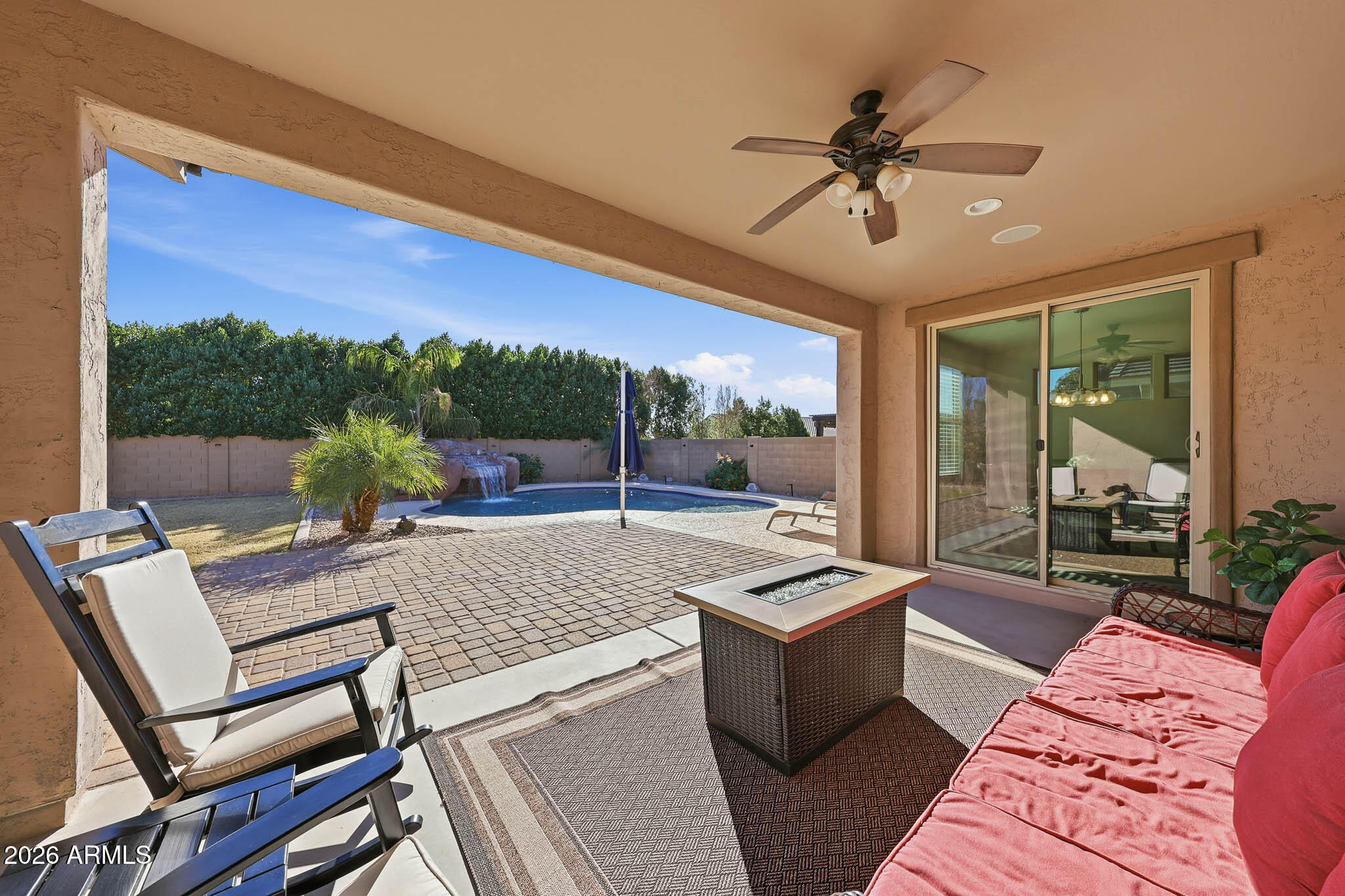 22133 East Russet Road Queen Creek, AZ 85142 - Photo 5 of 61 a living room with a couch a rug and a floor to ceiling window