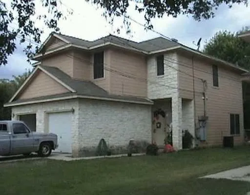 a front view of a house with a garden and yard