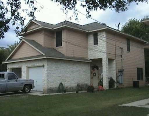 a front view of a house with a garden and yard