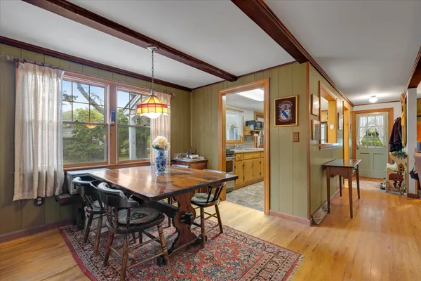a view of a dining room with furniture window and wooden floor