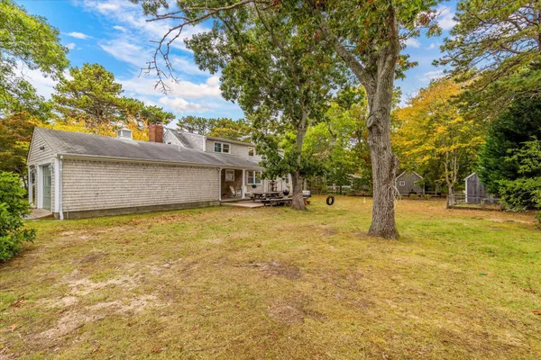 a front view of house with yard and trees