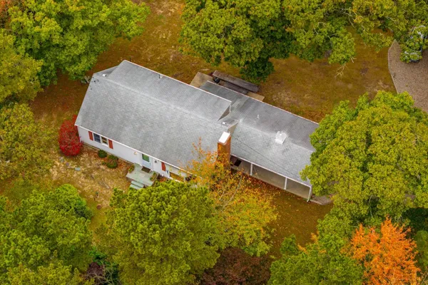an aerial view of a house with a yard and lake view