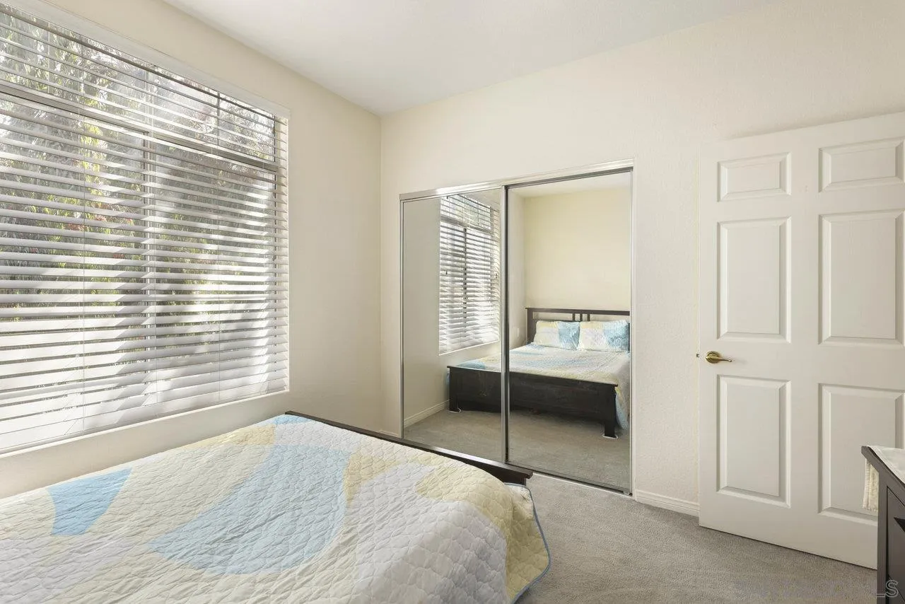 3365 Genoa Way, Unit 140 Oceanside, CA 92056 - Photo 20 of 32 a bedroom with a bed and a window