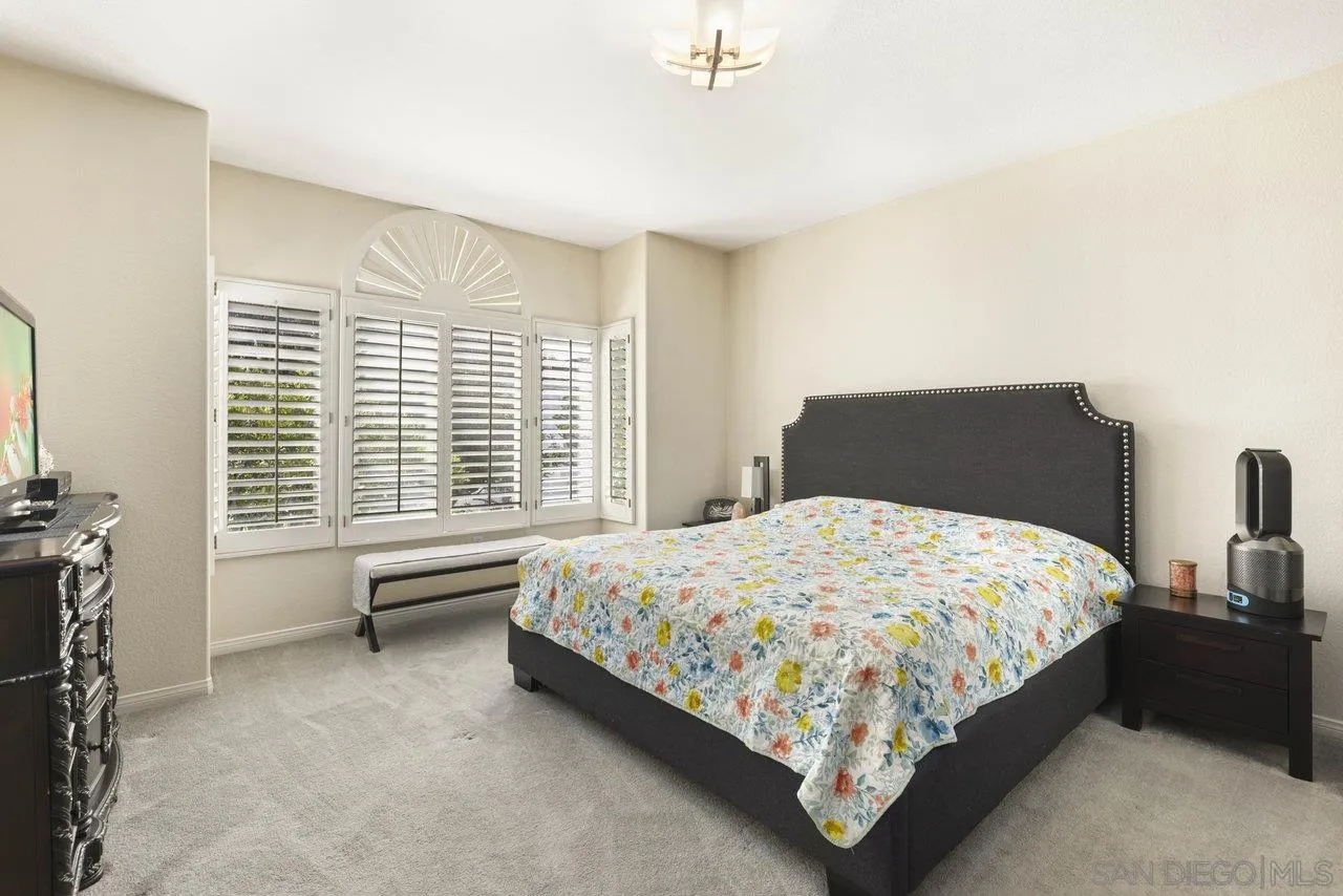 3365 Genoa Way, Unit 140 Oceanside, CA 92056 - Photo 22 of 32 a bedroom with a bed and a couch