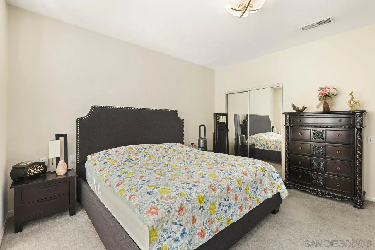 3365 Genoa Way, Unit 140 Oceanside, CA 92056 - Photo 23 of 32 a bedroom with a bed and dresser