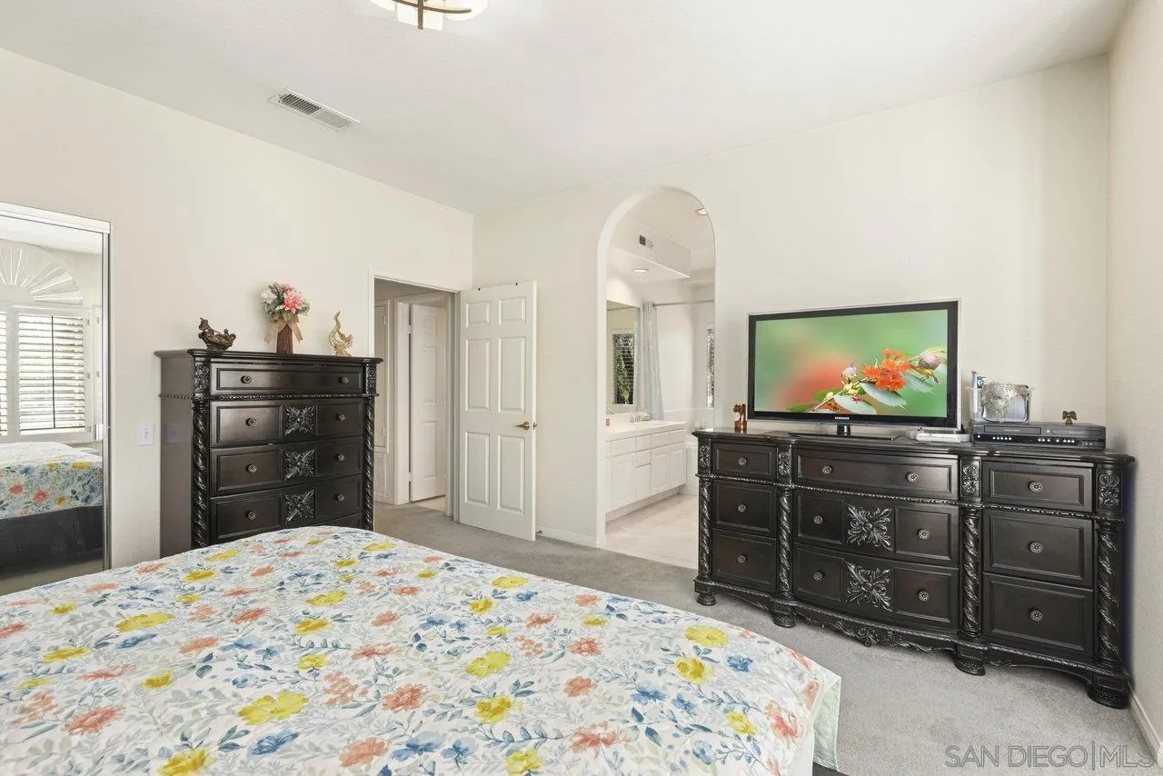 3365 Genoa Way, Unit 140 Oceanside, CA 92056 - Photo 24 of 32 a bedroom with a bed and a television
