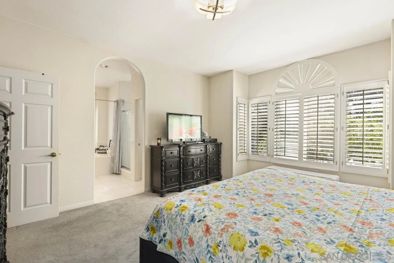 3365 Genoa Way, Unit 140 Oceanside, CA 92056 - Photo 25 of 32 a bedroom with a large bed and a large window