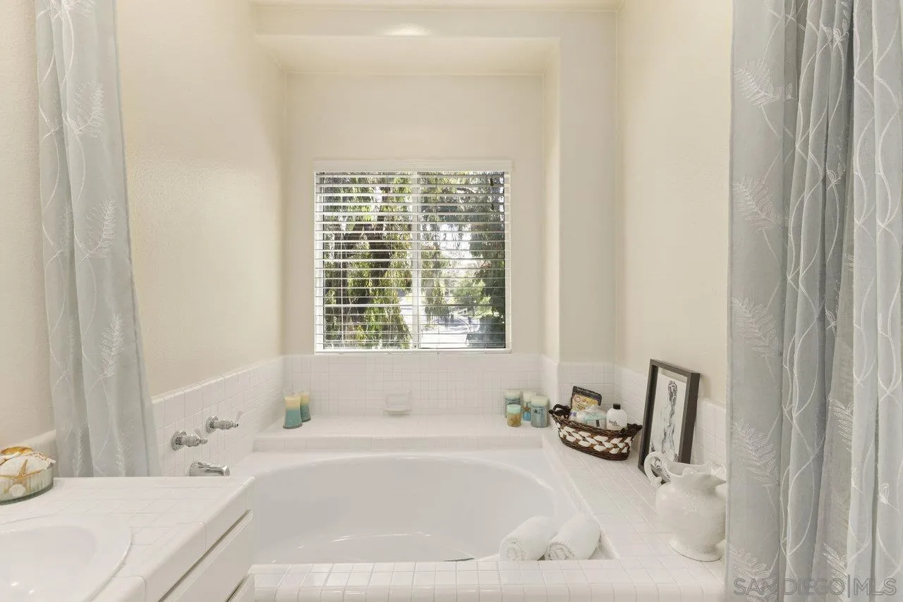 3365 Genoa Way, Unit 140 Oceanside, CA 92056 - Photo 27 of 32 a white bath tub sitting next to a white sink