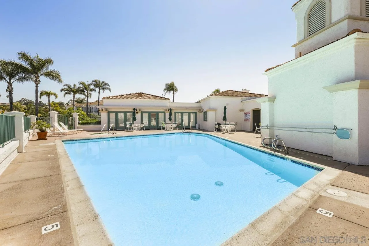 3365 Genoa Way, Unit 140 Oceanside, CA 92056 - Photo 30 of 32 a front view of a house with swimming pool and porch