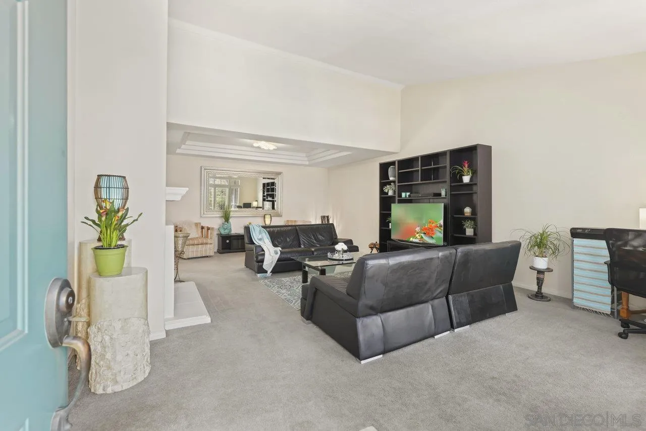 3365 Genoa Way, Unit 140 Oceanside, CA 92056 - Photo 4 of 32 a living room with furniture and a flat screen tv