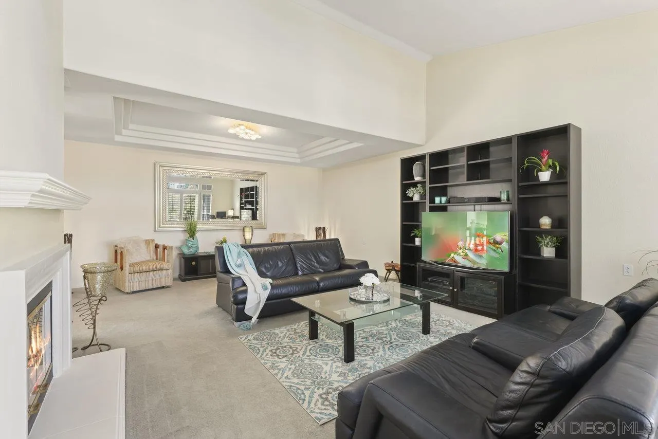 3365 Genoa Way, Unit 140 Oceanside, CA 92056 - Photo 7 of 32 a living room with furniture and a flat screen tv