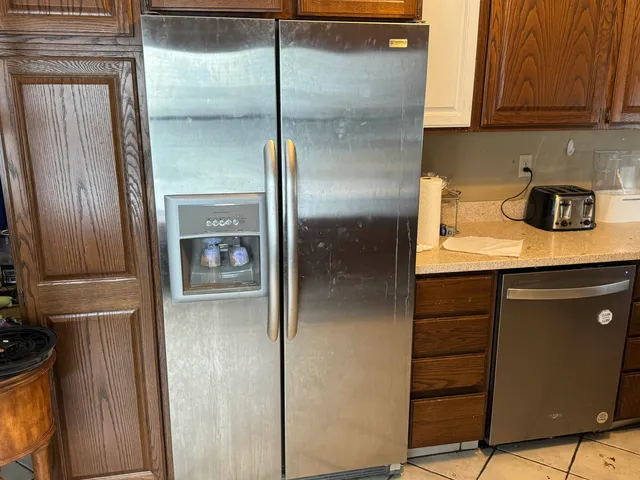 a kitchen with a refrigerator and cabinets