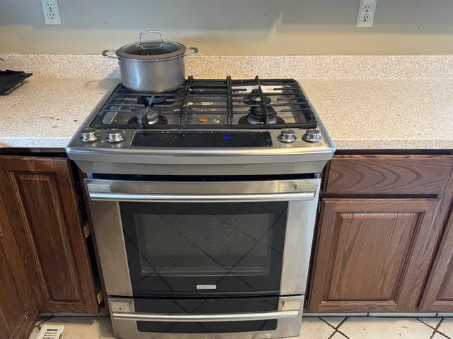 a stove top oven sitting inside of a kitchen