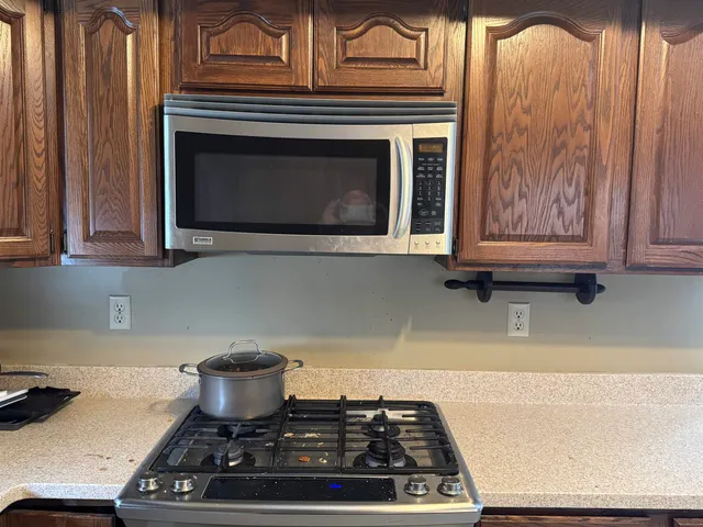 a stove top oven sitting inside of a kitchen