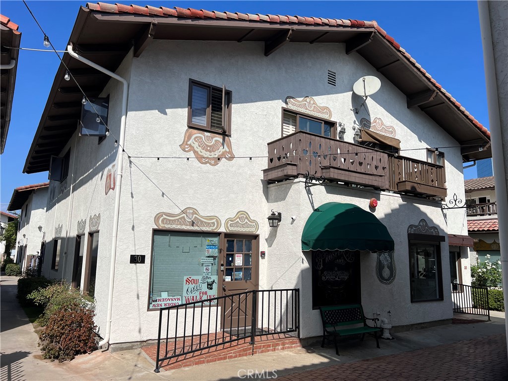 7561 Center Avenue, Unit 30 Huntington Beach, CA 92647 - Photo 1 of 1 a front view of a house with parking space