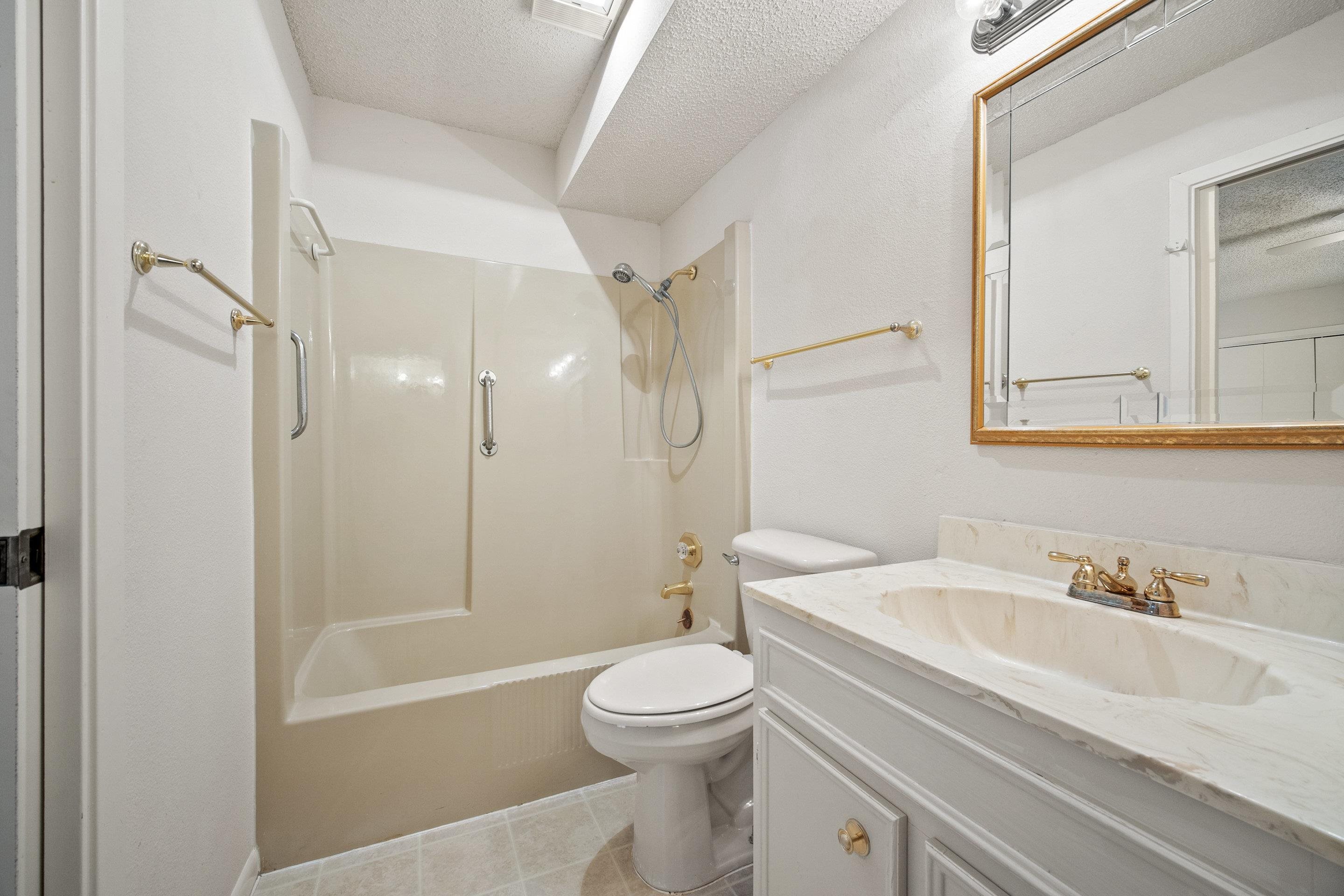 1201 Ranch Road 1431, Unit 2 Marble Falls, TX 78654 - Photo 14 of 26 a bathroom with a sink a toilet and a mirror
